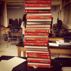Senior Leslie Blalock breaks the Foundations of Technology record for stacking 25 textbooks on her paper structure.