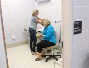Health techs Beth Jordan and Cheryl Jones set up the Gaithersburg center.