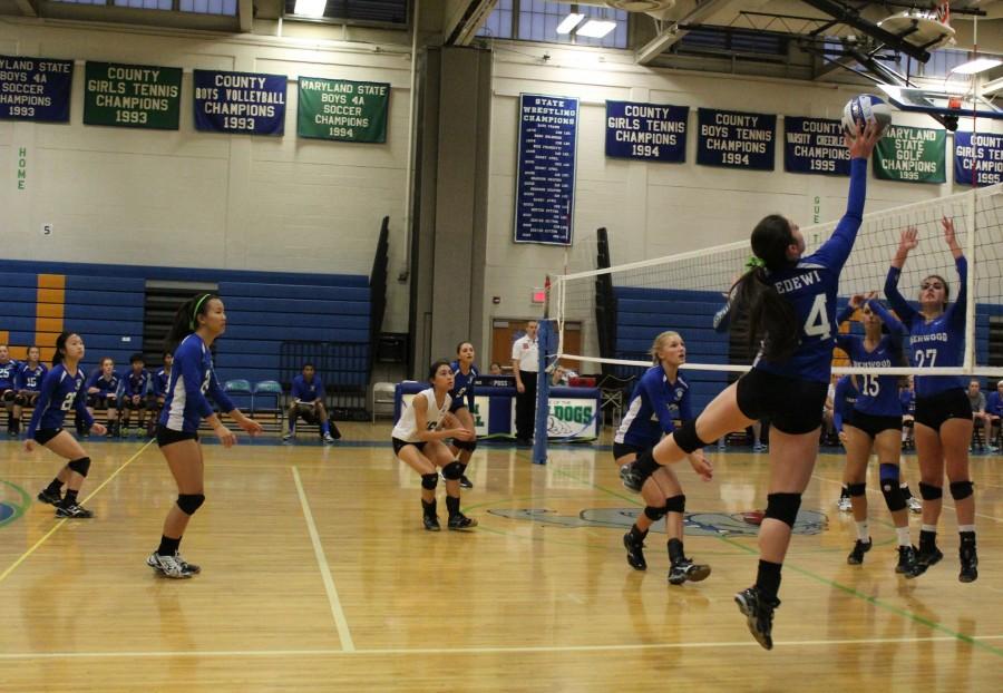 Senior Lucy Bedewi tips the ball over the net during a recent match.