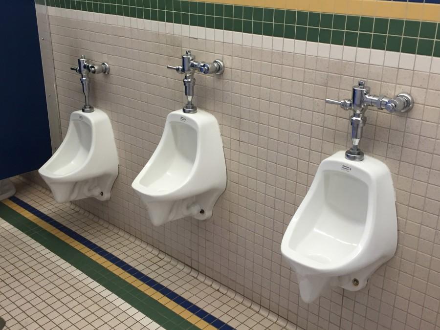 The lack of dividers between urinals makes boys unwilling to use them due to awkward closeness and lack of privacy.