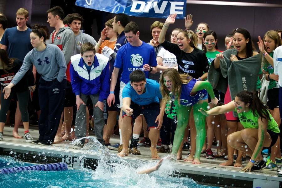 The swim and dive team cheers during the swimming finals at Metros