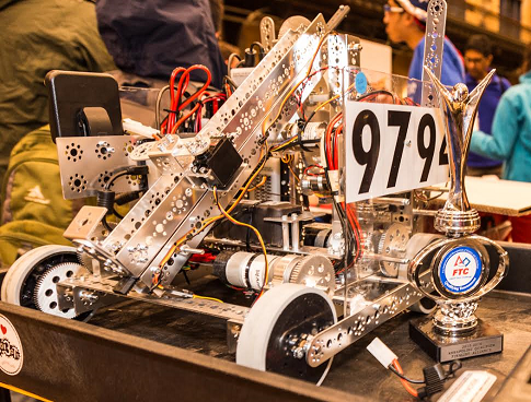The team’s robot climbs up the ramp during the competition.