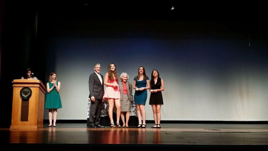 Superintendent Bowers presents seniors Natalie Hwang, Anna Votaw and Valerie Weitz with awards for theater excellence