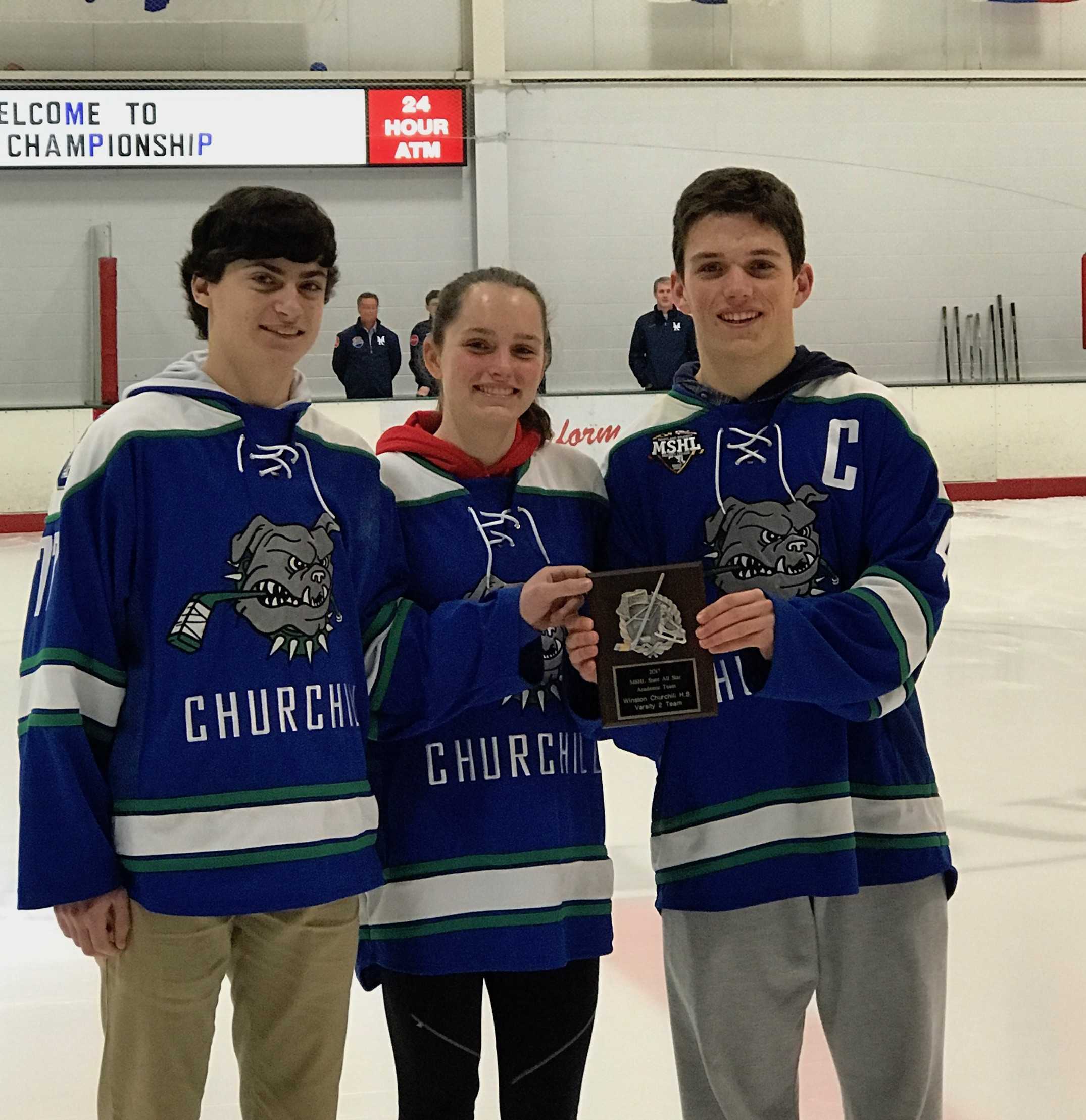 Juniors Ben Stanish, Kate Danziger and Cameron Miller accept the MSHL academic award during the pre-game ceremonies of the varsity hockey state-championship game.