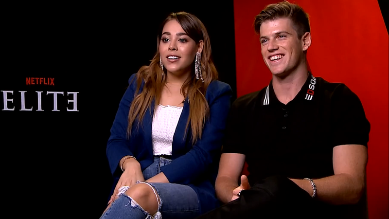 Elite stars Miguel Bernardeau and Danna Paola sit together during an interview. In the show, the two are in a dramatic off-on relationship. 