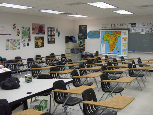 
The stereotypical classroom of wooden desks and chairs awaits high school students. 