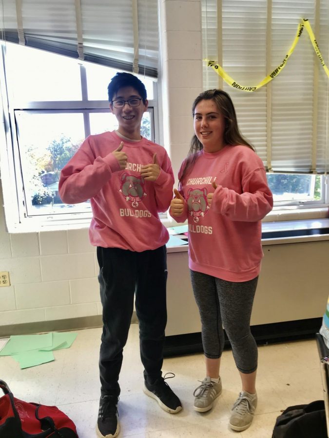 Juniors+Brian+Hung+and+Grace+Merola+rock+the+pink-out+sweatshirts+during+world+history+class.+The+pink-out+sweatshirts+were+worn+by+many+%0AWCHS+students.