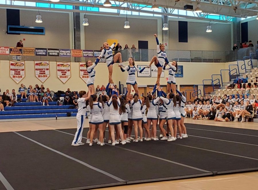 The WCHS cheer team stunts at the MCPS regional competition. The team has been practicing these elaborate tricks all season.