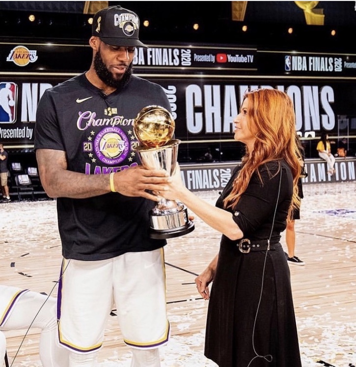 Los+Angeles+Lakers+NBA+finals+MVP+Lebron+James+stands+next+to+reporter+Rachel+Nichols+as+the+two+hold+his+newly+won+NBA+Finals+Larry+O%E2%80%99Brien+Trophy.+Nichols+was+the+main+sideline+reporter+covering+the+game+in+which+Lebron+won+his+fourth+ever+championship%2C+and+has+built+a+strong+relationship+with+players+like+Lebron+over+her+many+years+reporting+on+the+league.+