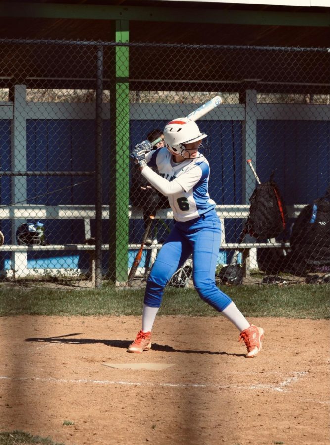 Daniella Lew, who wears number six on her jersey, gets in her batting stance at a home game. Pre-COVID, Lew played many in-person games, both at WCHS and at the opposing schools. 