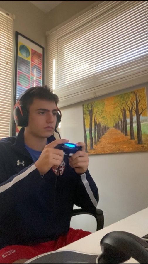 Micheal Demske grips his Ps4 controller in his home when he realizes that he is procrastinating. Micheals resolution is to stop procrastinating so he has made schedules to keep him on task.