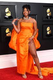 Megan thee Stallion smiles for the cameras on the red carpet as her photo is taken. She swept the Grammys this year, winning 3 awards. 