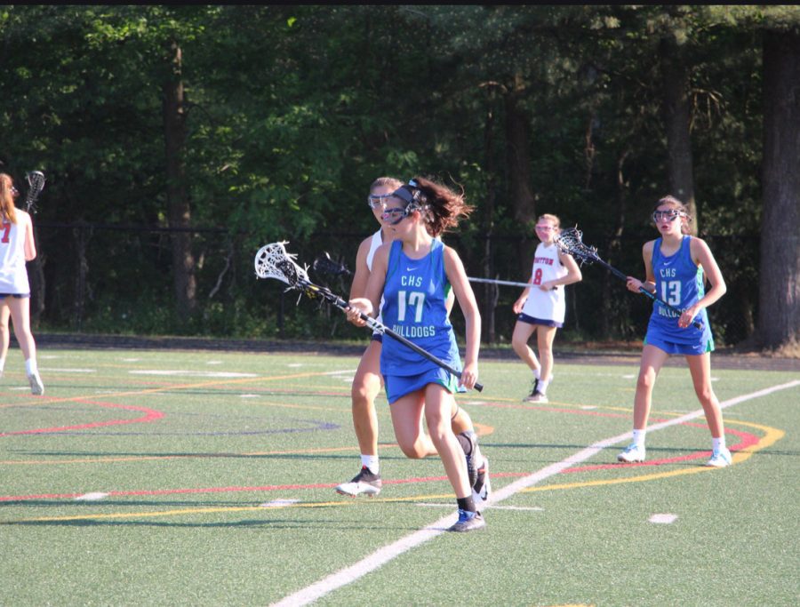 Lexie+Levitt+runs+past+defenders+on+her+way+to+scoring+a+goal+for+the+WCHS+JV+Lacrosse+Team.