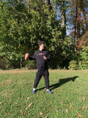 Extending his arm back while throwing a football, WCHS junior plays football on a local field in anticipation for his Mud Bowl game on Thanksgiving. 