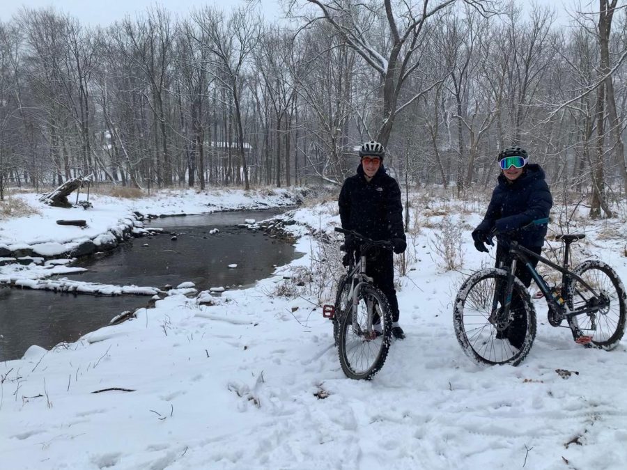 Alec Lehtman goes biking through the snow with Josh Heimlich during a snow day.