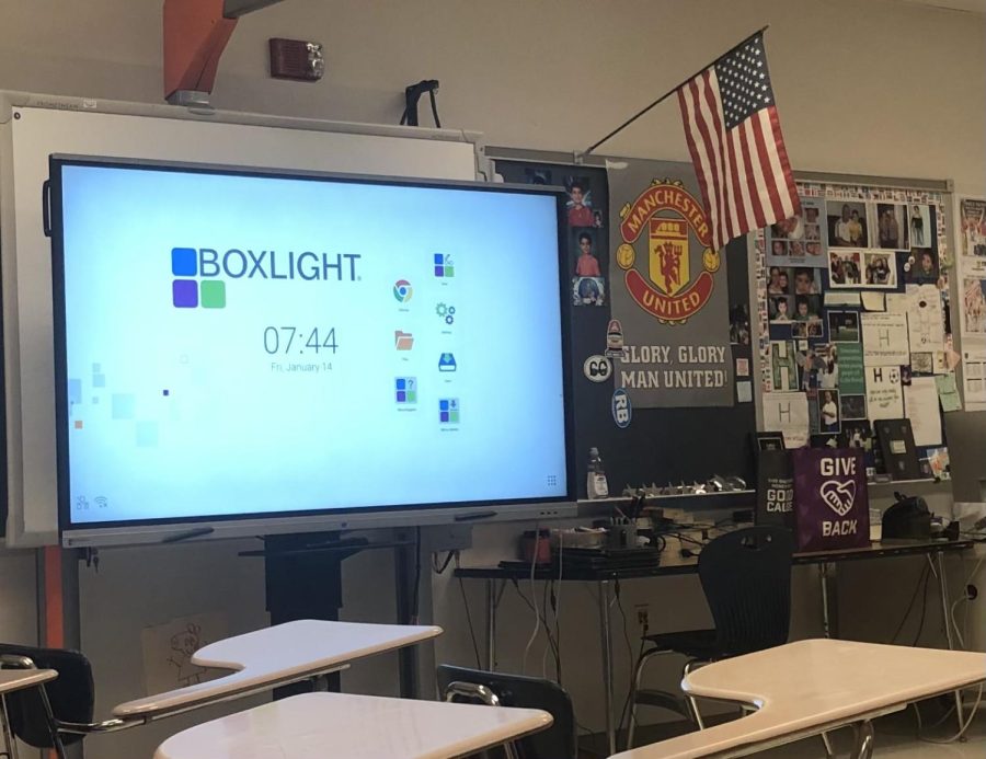 Boxlight boards have been placed a large number of classrooms like this one. Here one is powering up as Mr. Hakopian begins class.