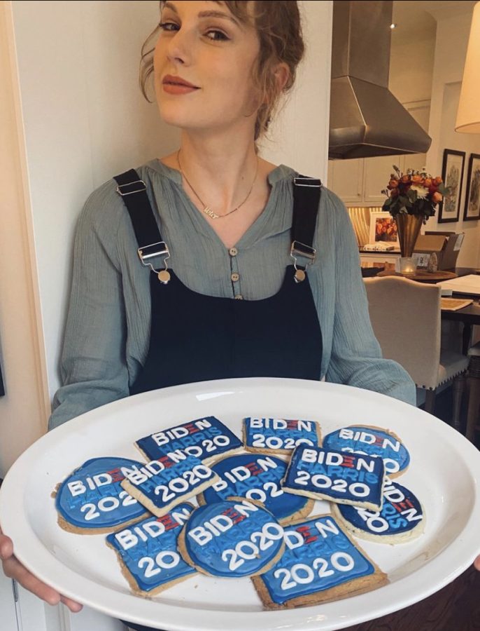 An Instagram post from artist Taylor Swift features her holding a plate of cookies decorated with the now president's name. This is an example of celebrities using social media to influence their fans.