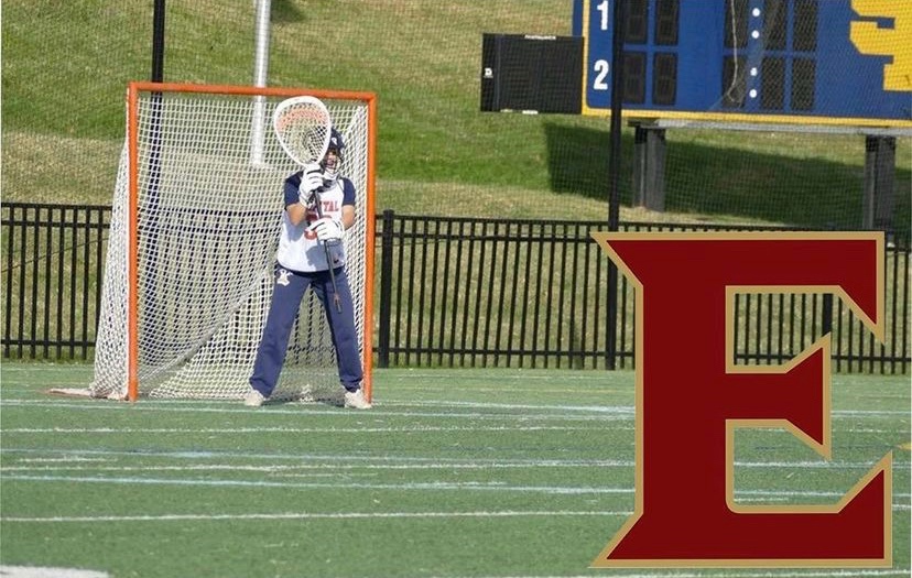 Junior Anna Rubino on the lacrosse field with a logo of Elon University, where she recently committed to play, in the bottom-right corner.
