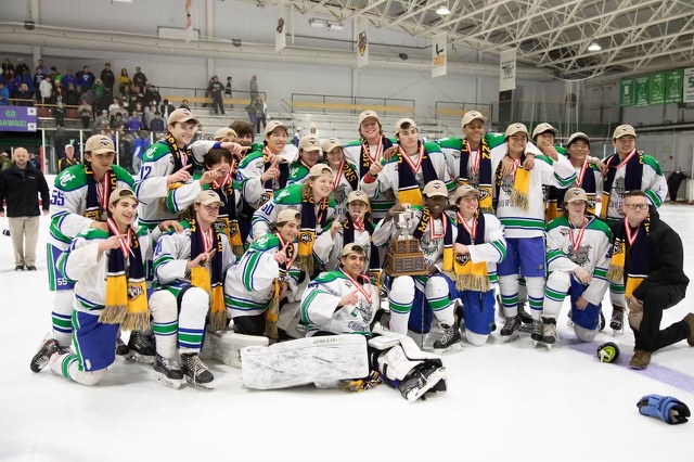 The WCHS Varsity Hockey team poses with their trophy after winning their 10th state championship title