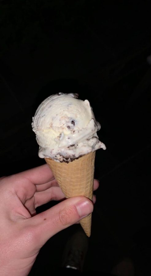 A cone holds an oreo flavored scoop from Sprinkles Ice Cream in Potomac