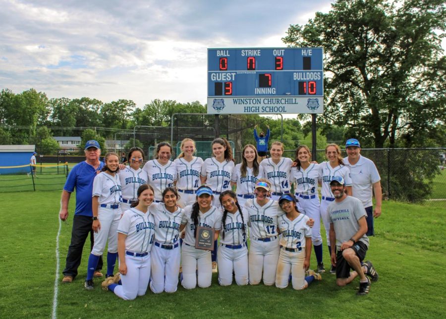 The+WCHS+varsity+softball+team+poses+with+the+regional+championship+plaque+after+defeating+Walt+Whitman+high+school.