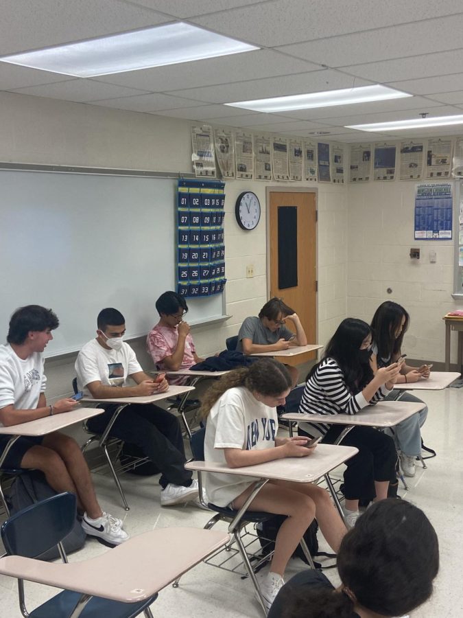 WCHS students are seen sitting on their phones in class during free time. Under the new PMD policy, students are not permitted to use their phones during class time at all.