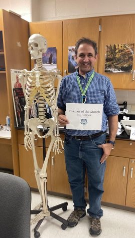 Mr. Fishman, the Anatomy and Physiology teacher at WCHS, uses his human skeleton model to assist his students with a visual representation to relate to their learning.
