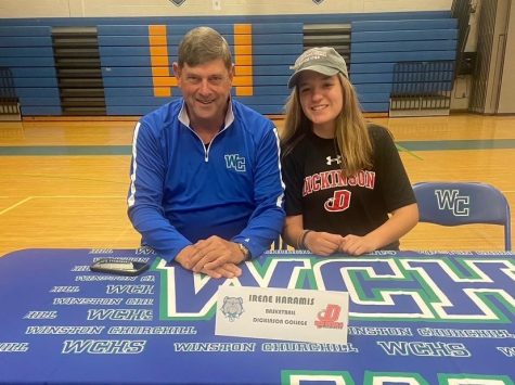 WCHS graduate Irene Haramis confirms her commitment to Dickinson College in the WCHS gym with support from her coach, Pete McMahon.