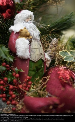 Santa and a stuffed bear look over the world in a jungle of beautiful leaves.