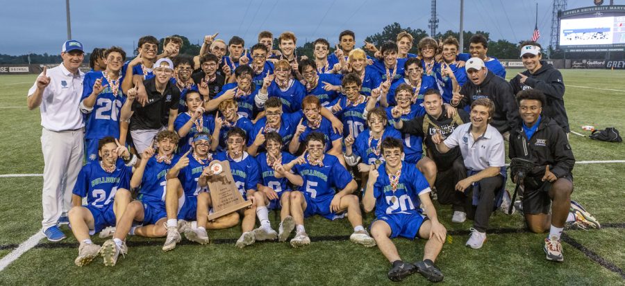 The+WCHS+boys+lacrosse+team+poses+with+the+trophy+after+winning+the+2022+Maryland+state+championship.+