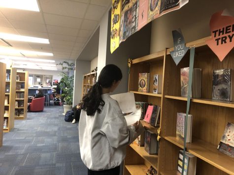 WCHS sophomore Aida Sadjadpour browses through a packet with a list of BES nominees at the media center during lunch.