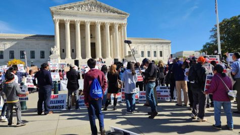 Protestors stand outside the Supreme Court on Oct. 30, a day before the beginning of arguments regarding the status of affirmative action at U.S. colleges.