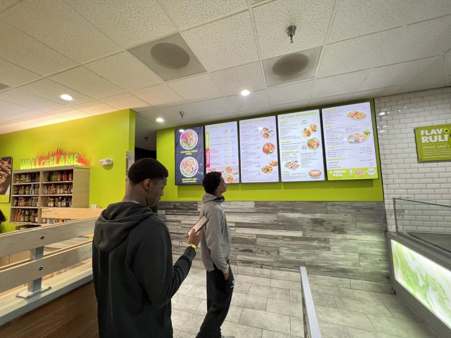 WCHS seniors Ezekiel Avit and Isaiah Mbeng examine the new California Tortilla menu on April 14, shortly after the reopening.