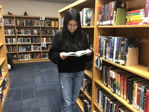 WCHS student Thao Nguyen reads Daisy Jones & The Six in the media center during lunch. Nguyen loves the TV show as well as the book, and is excited to read more this summer.
