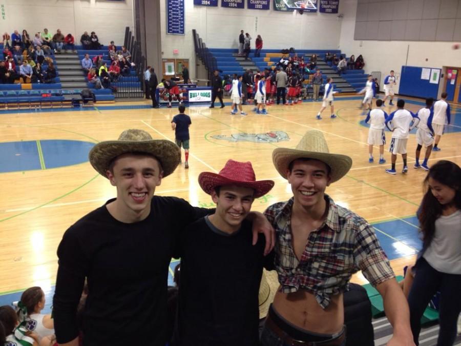 Seniors Erik Johnson, Justin Spivack and Chris Hallock all support the boys basketball team on Dec. 23. 