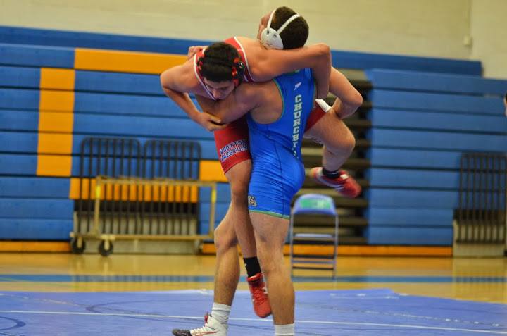 Senior Guilian Groce challenges his opponent in a match between CHS, Wootton and Watkins Mill high school on Feb. 7. 