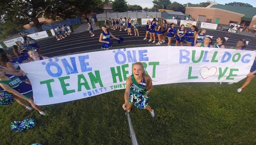 Senior+Evangeline+Pergantis+uses+a+GoPro+camera+and+selfie+stick+to+capture+the+entire+cheerleading+team.+