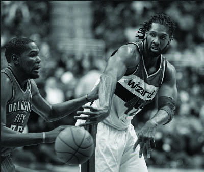 Wizards power forward Nene makes a pass in a game against the Oklahoma City Thunder