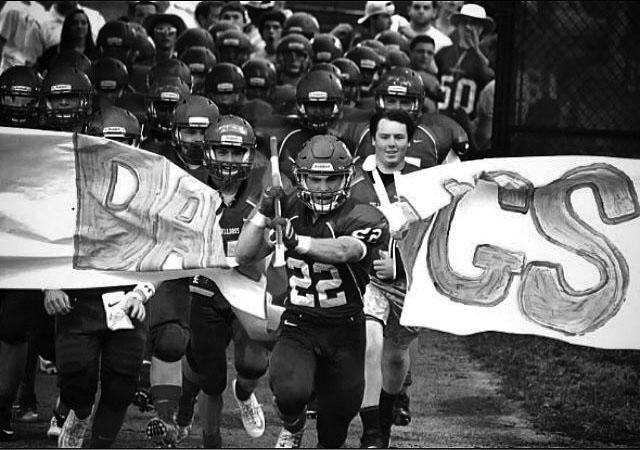 Led by senior captain Andrew Zuckerman, the Bulldogs charge the field during a recent game.