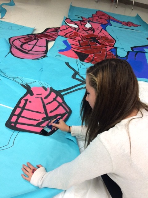 Sophomore Katherine Galvin works on the mural after school.