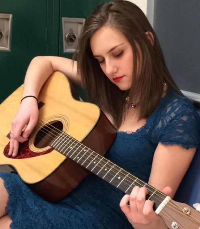 Senior Valerie Weitz plays the guitar to showcase her musical talent. Weitz will be involved in the Consenses Art Project this year.