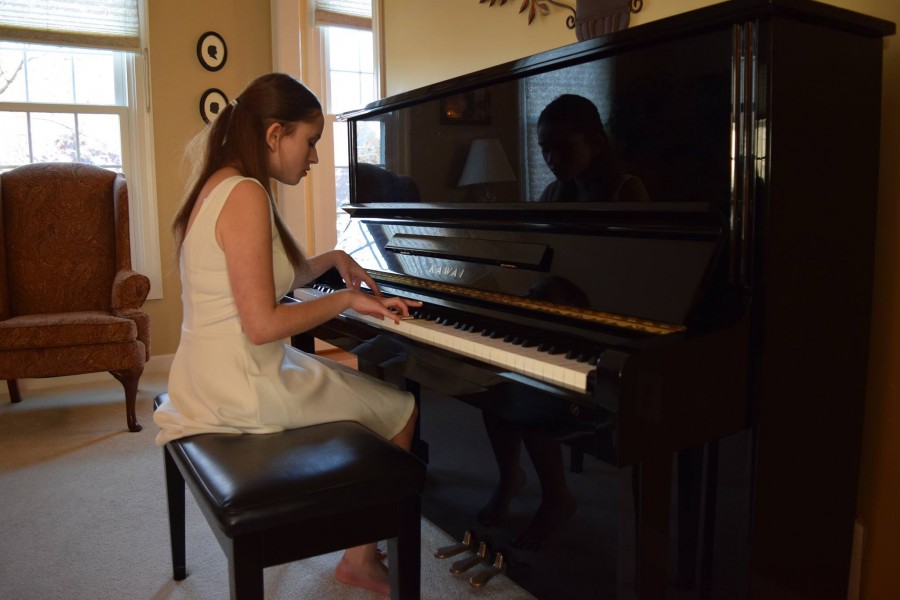 Safdie plays the piano as she records her music video for "Silhouettes."