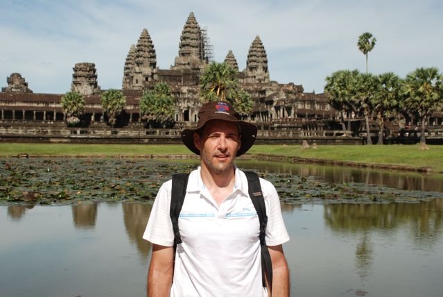 Forney poses in front of a temple in Southeast Asia.