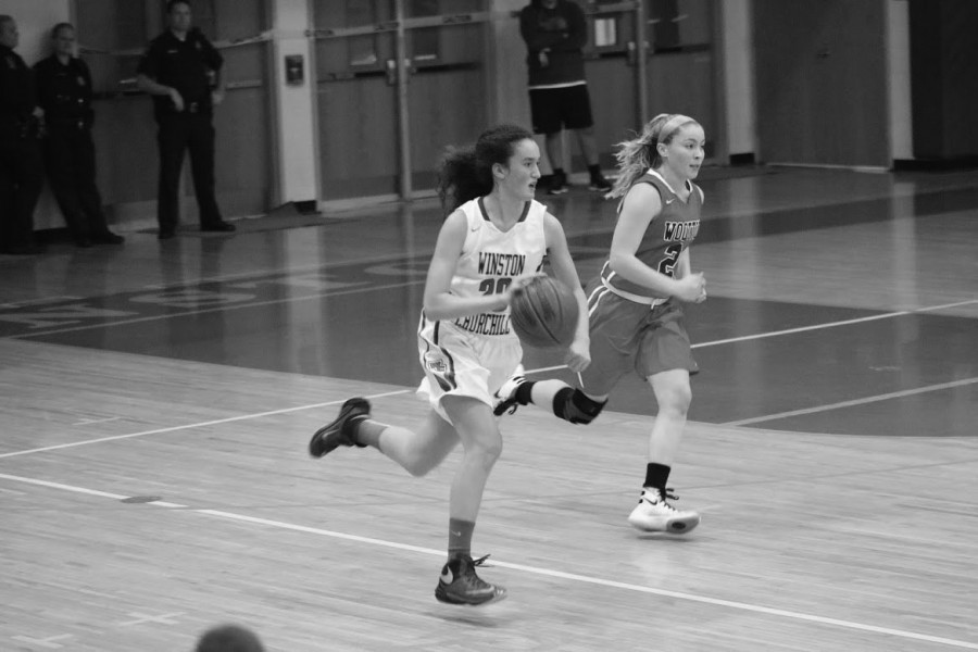 Kuchins dribbles the ball down the court during a recent game. She has led the team to a 14-4 record. 