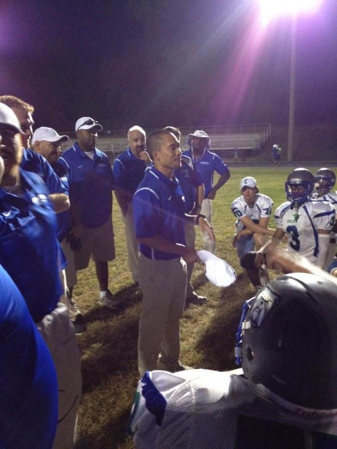 English teacher and football head coach Albert Song gives the team a pep talk before a game. 