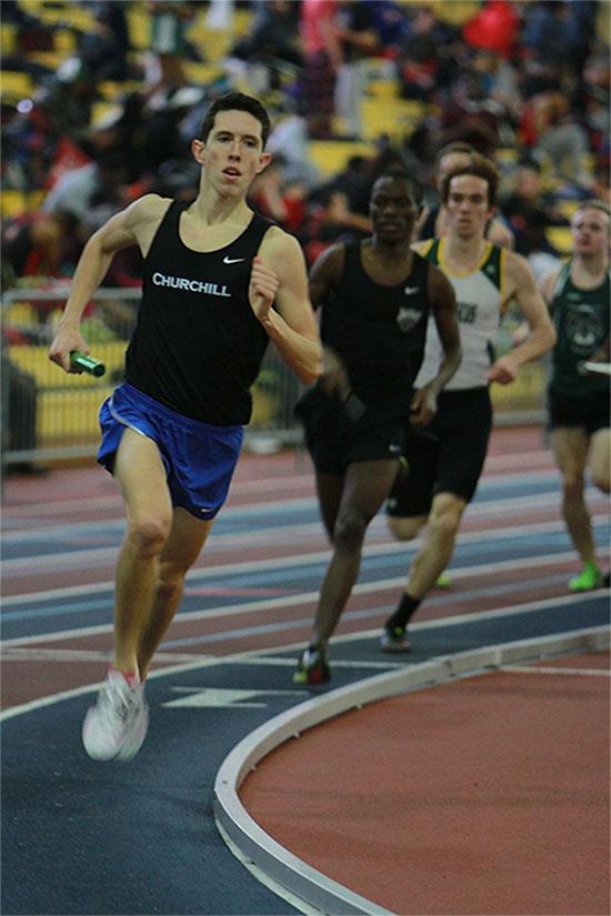 Senior Michael Hughes runs his leg of the relay.