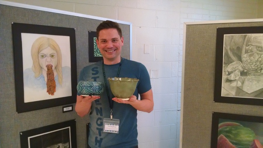 Art Department resource teacher Brendan Roddy displays original pottery that will be raffled off during the Arts Festival  April 19-29. 