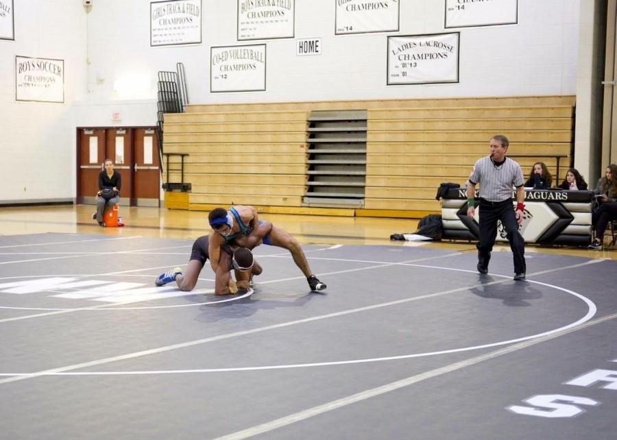 Senior captain JJ Bravo sets an example for his wrestling teammates as he gets ready to take on his opponent. Bravo has led the team this season to a 26-6 record in tournaments and a 10-4 record in dual meets.