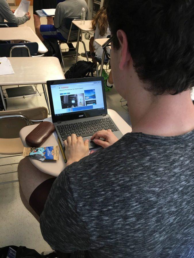 Senior Elliot Sloate  gets distracted by games on his chromebook during a class.
