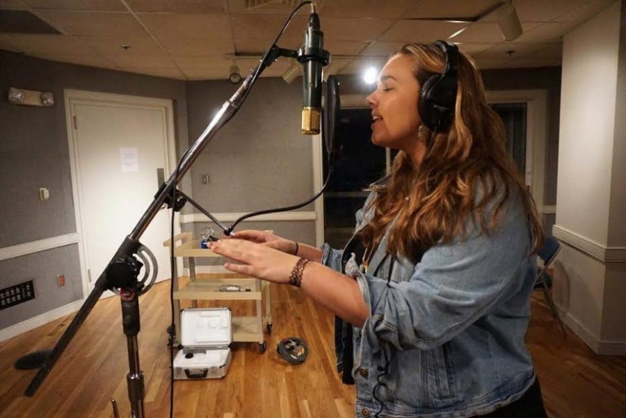 Alumna Kristina Hann works on her music in a recording studio. Hann is currently studying Music at Belmont University.